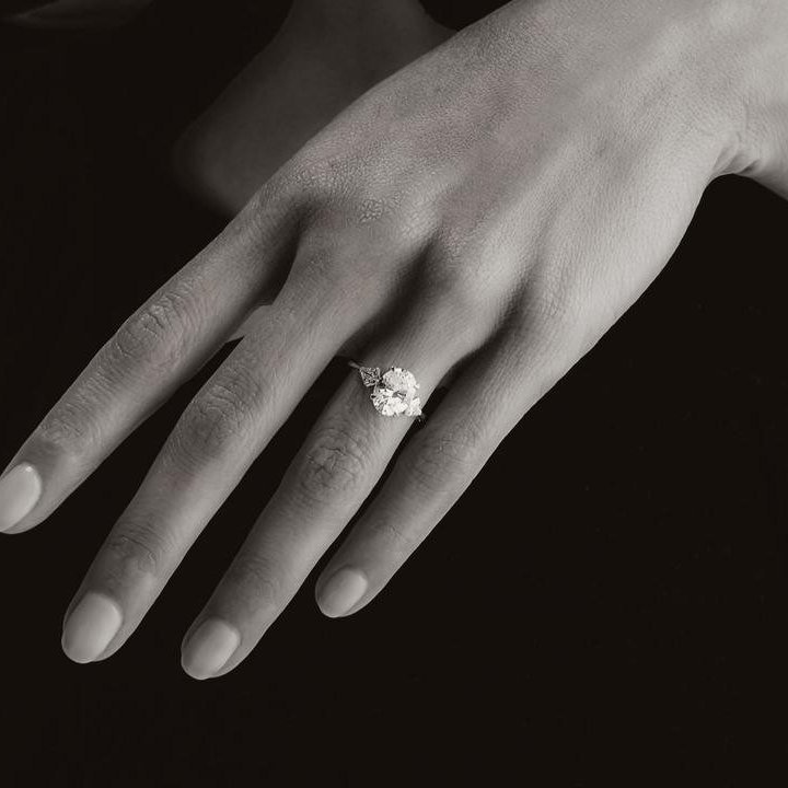 Oval three-stone engagement ring, worn